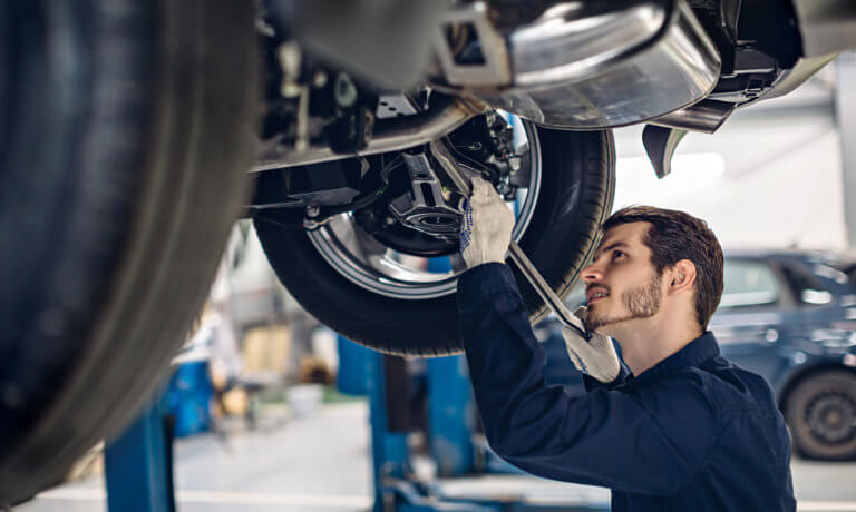 Technician working under a car